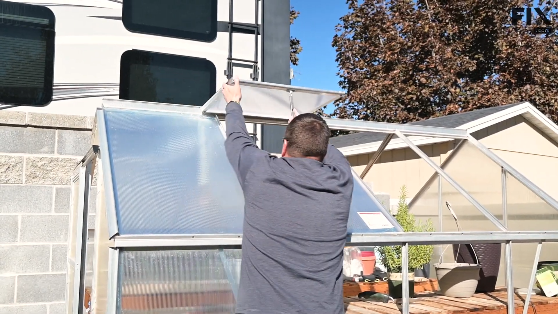 Expert technician placing the vent and partition pieces back into a greenhouse after removing them