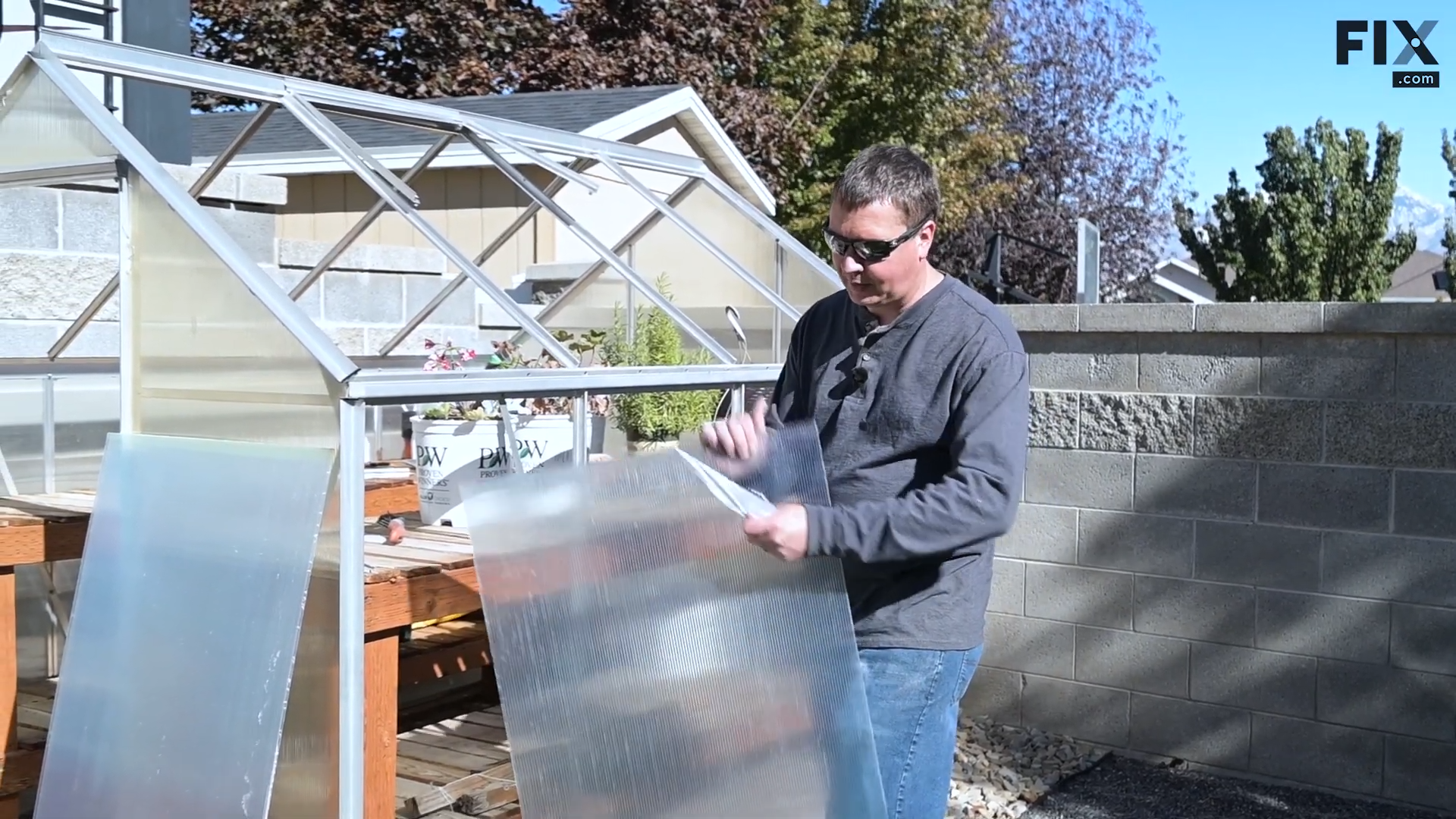 Expert technician removing the protective clear film on the double-wall polycarbonate