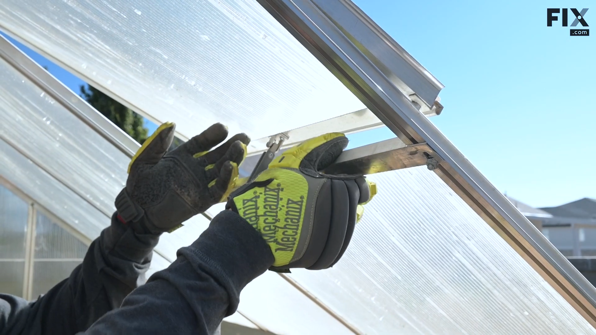 Expert technician removing the partition separating the panels of a greenhouse vent